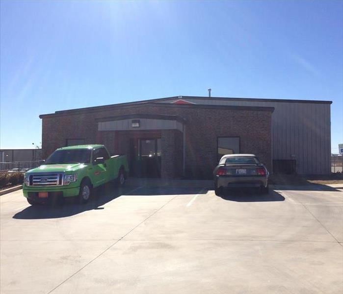 Front of SERVPRO structure with green SERVPRO truck out front.