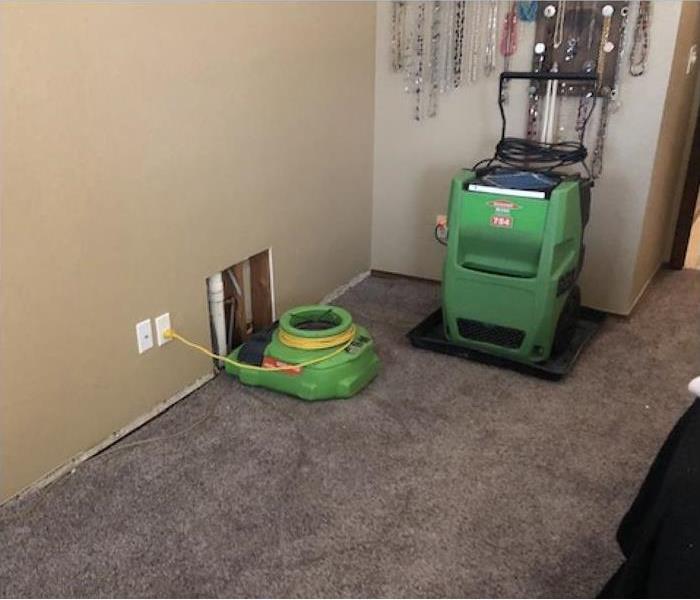 air mover and dehumidifier placed on a rug